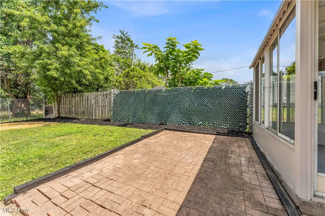 Fenced backyard featuring a patio