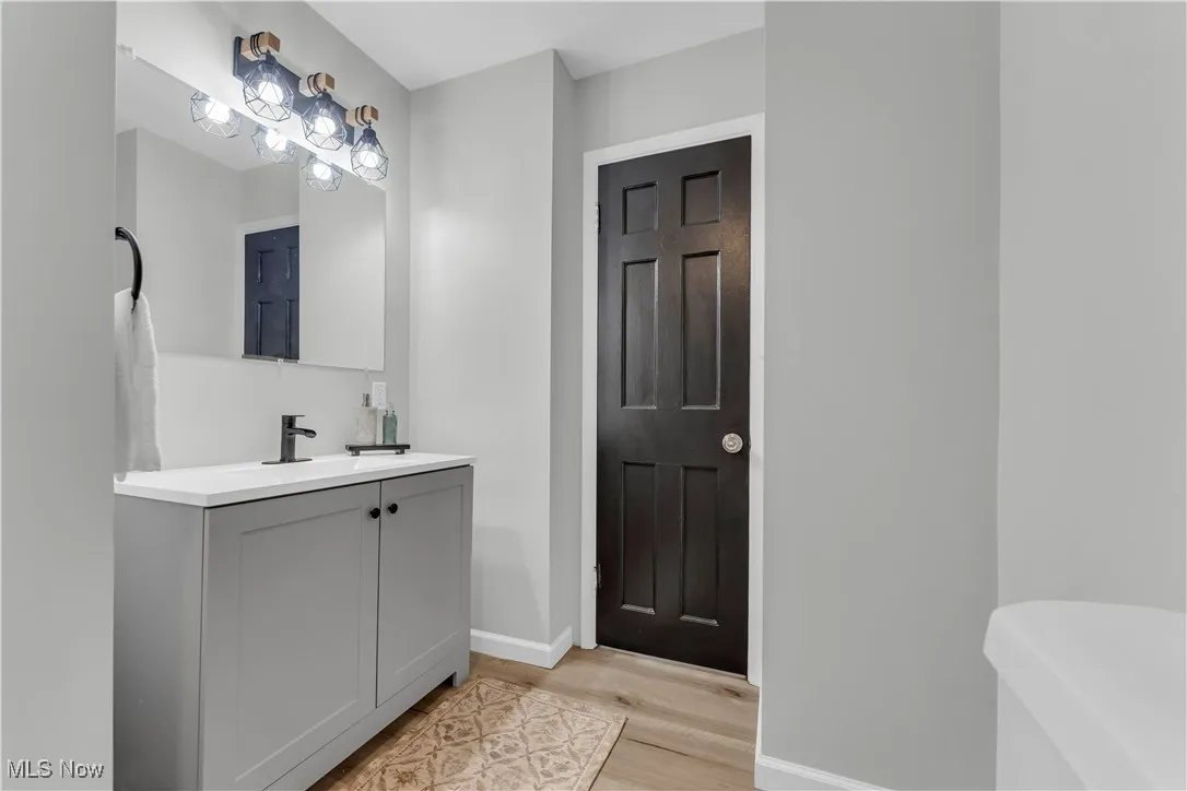 Bathroom with vanity and wood finished floors