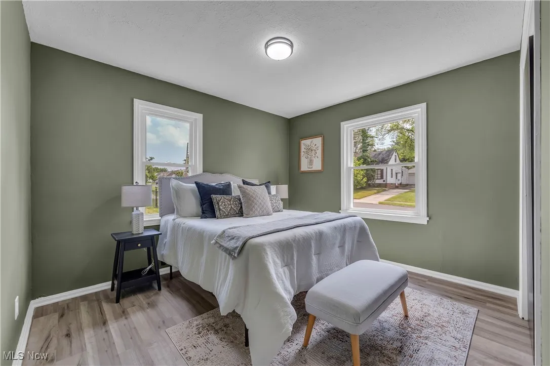 Bedroom featuring light wood-style floors and a textured ceiling