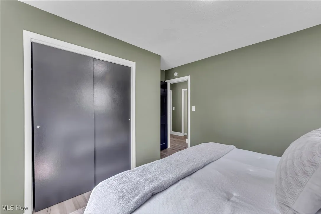 Bedroom featuring wood finished floors and a closet