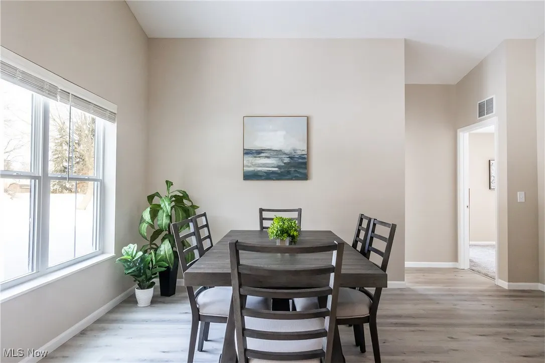 Dining room featuring light wood-style flooring and baseboards