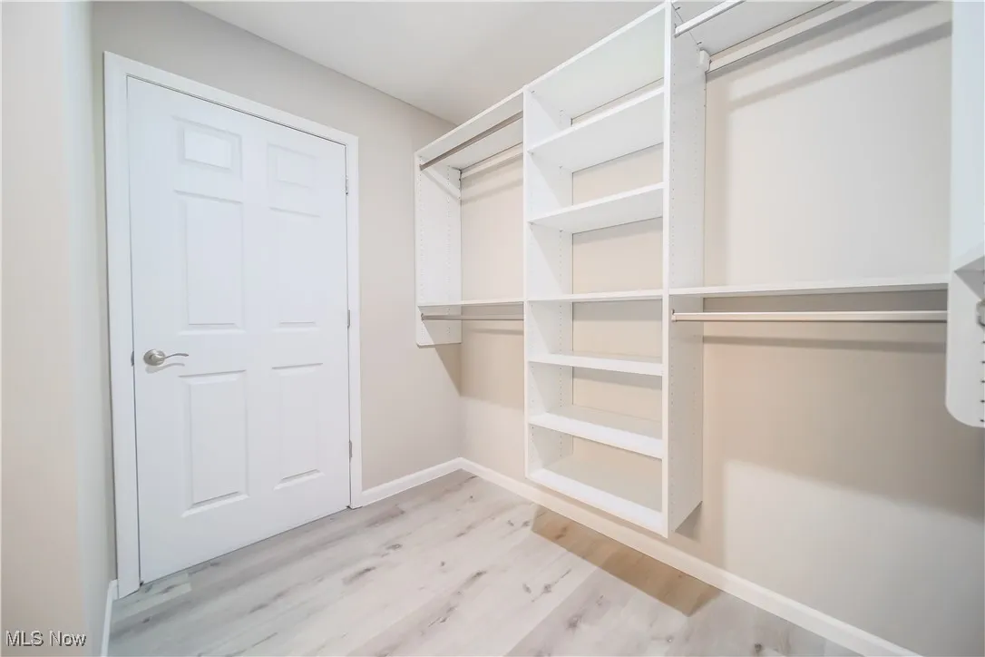 Spacious closet with wood finished floors