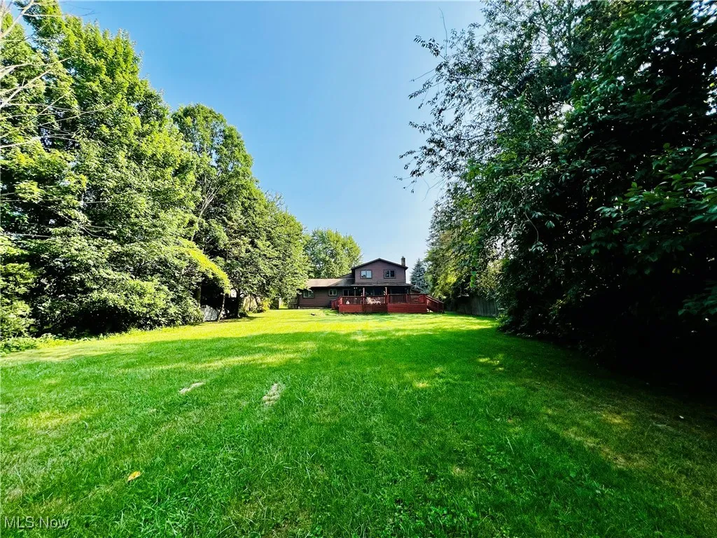 View of green lawn with a deck