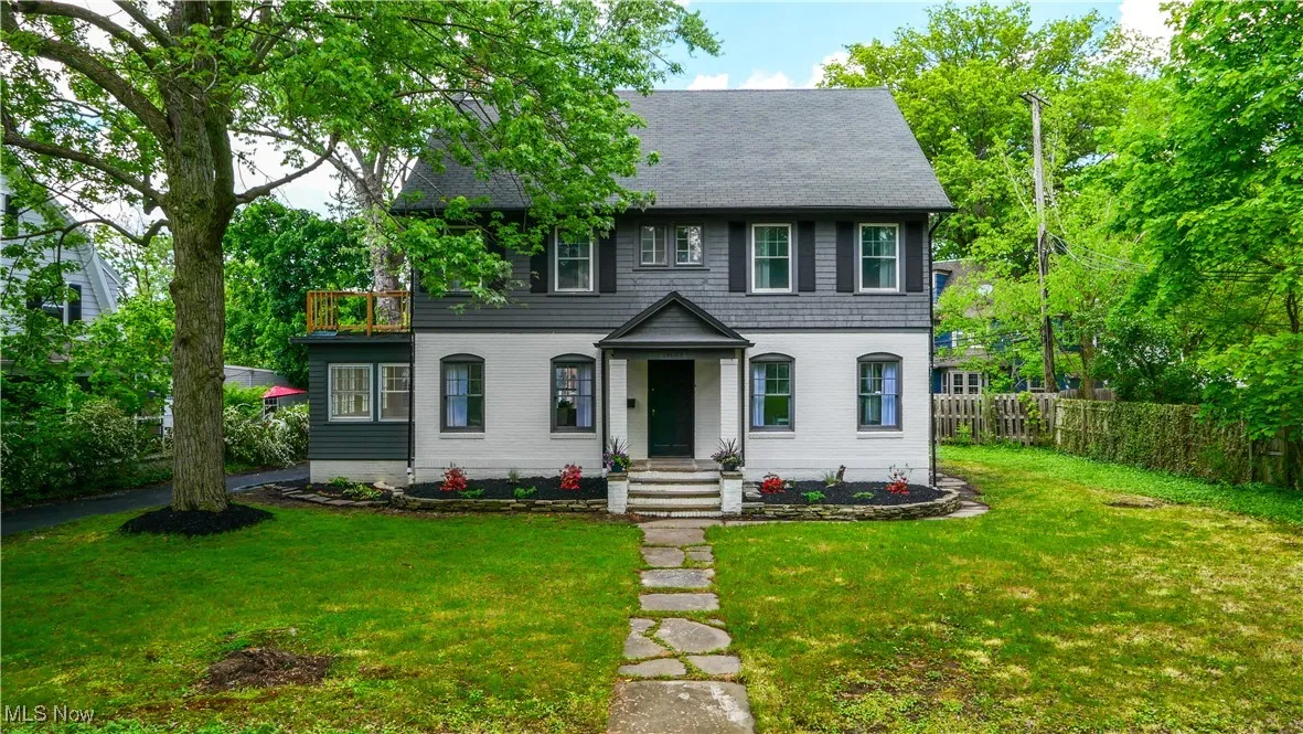 View of front of house with a shingled roof