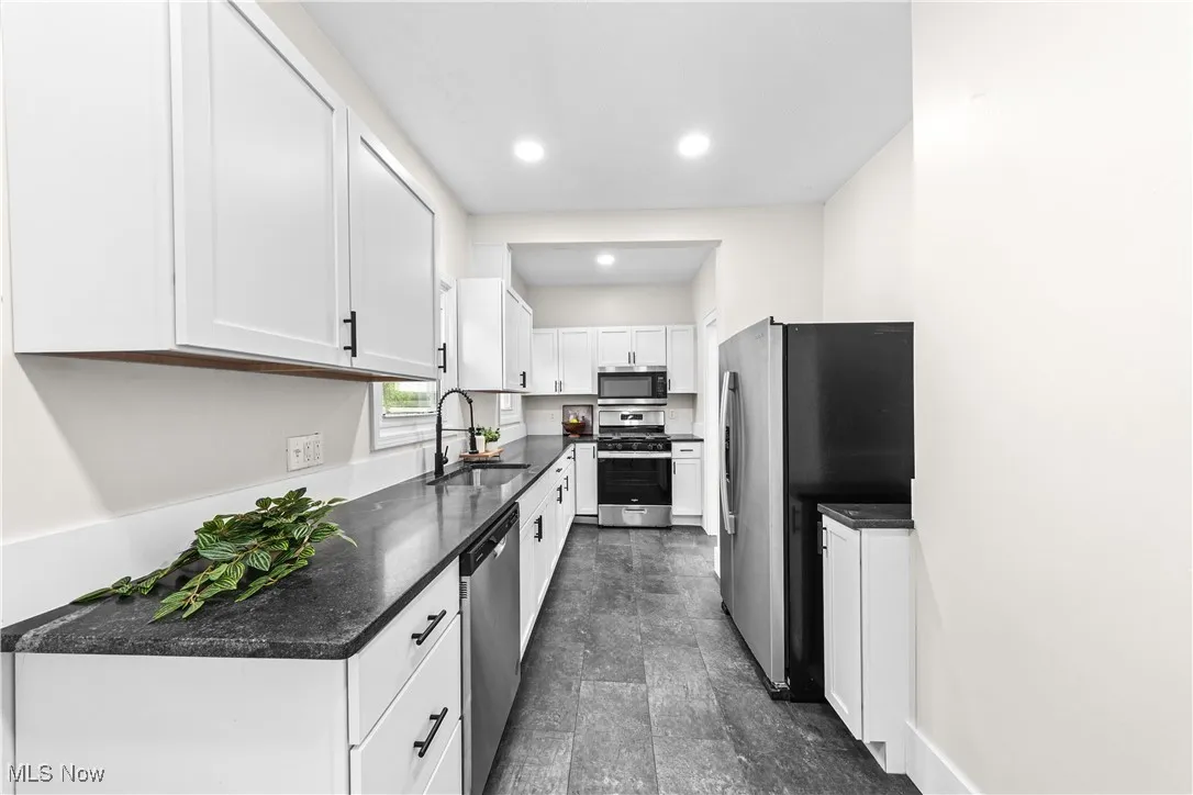 Kitchen with appliances with stainless steel finishes, white cabinetry, and recessed lighting