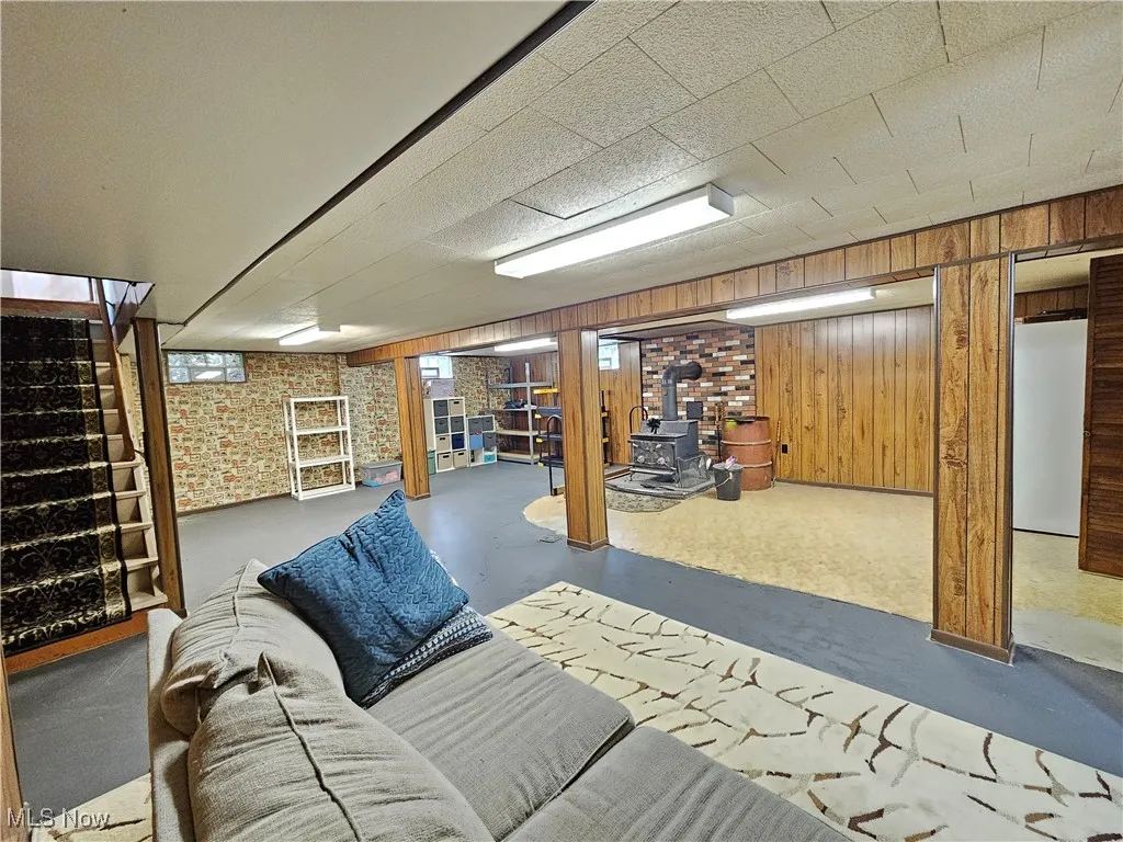 Basement featuring recreation area and wood stove