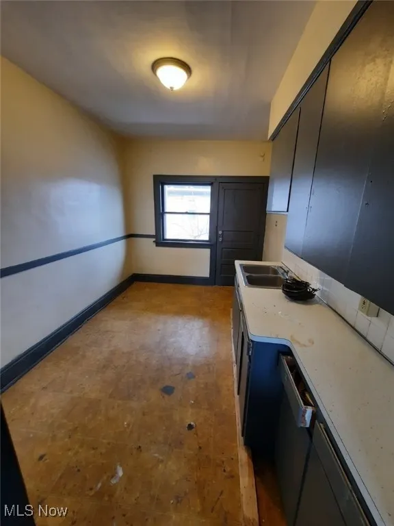 Kitchen with light countertops and tile patterned floors