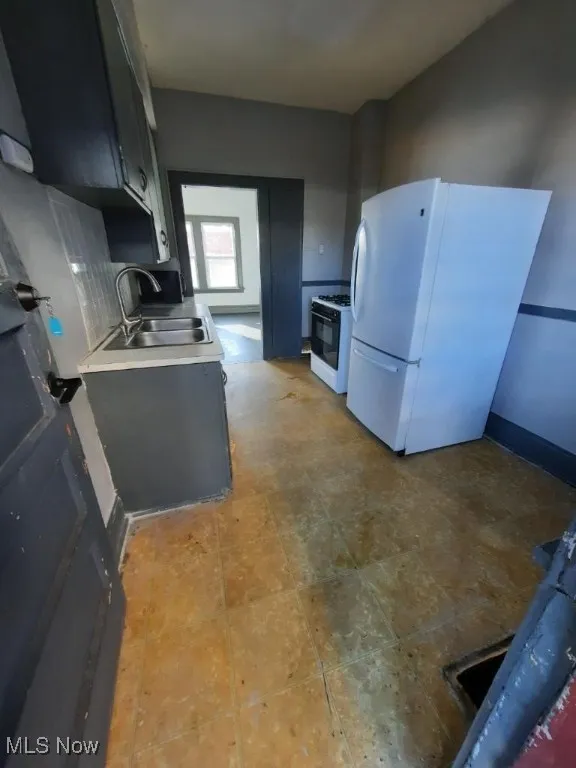 Kitchen featuring white appliances and light countertops