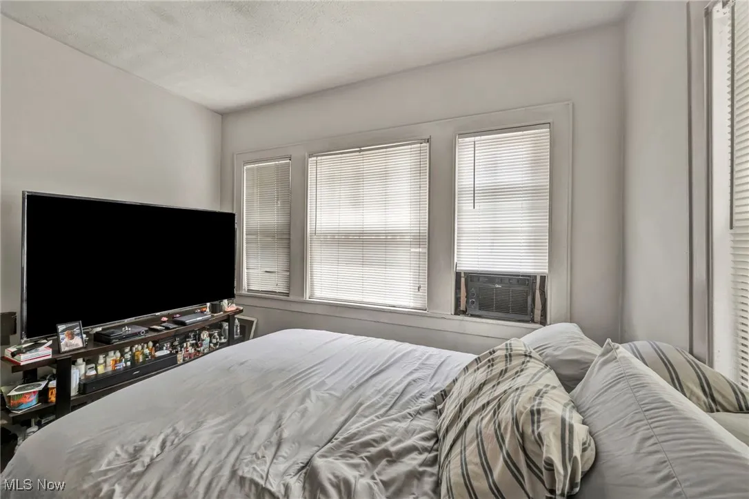 Bedroom featuring a textured ceiling and cooling unit