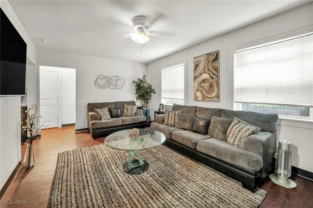 Living area featuring wood finished floors and a ceiling fan