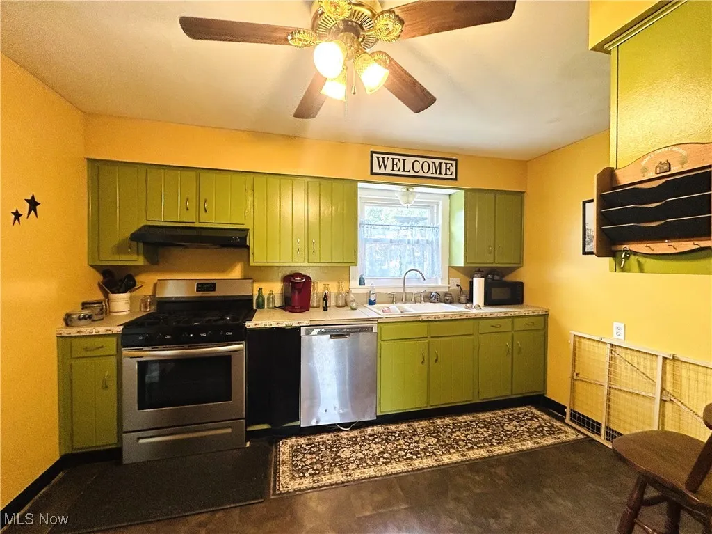 Kitchen with green cabinets and appliances