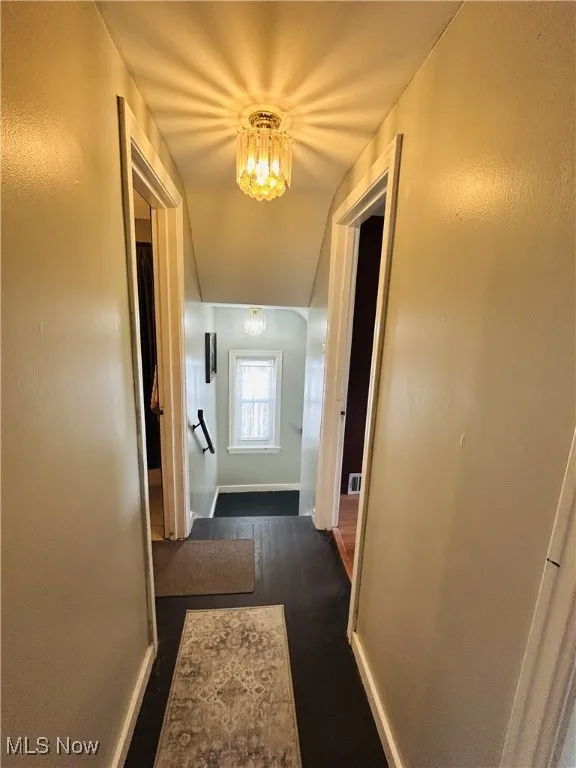 Hall featuring a chandelier