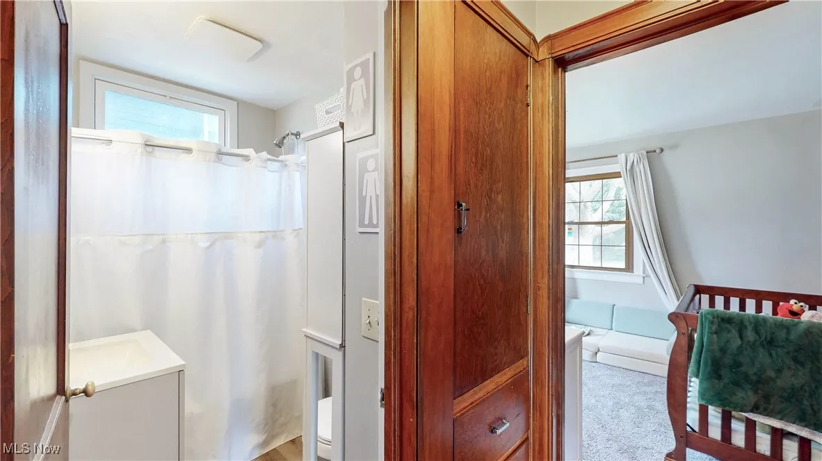 Bathroom featuring curtained shower