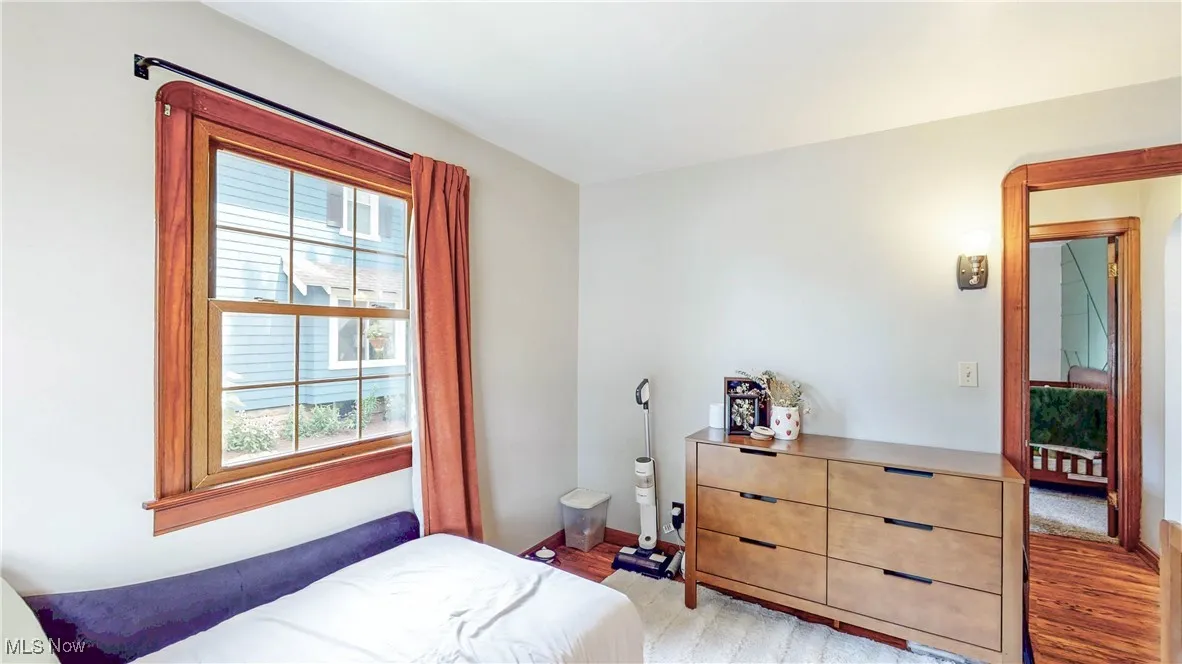 Bedroom with light wood-style flooring and baseboards