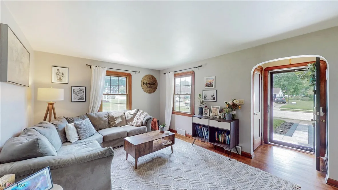Living area featuring wood finished floors and arched walkways