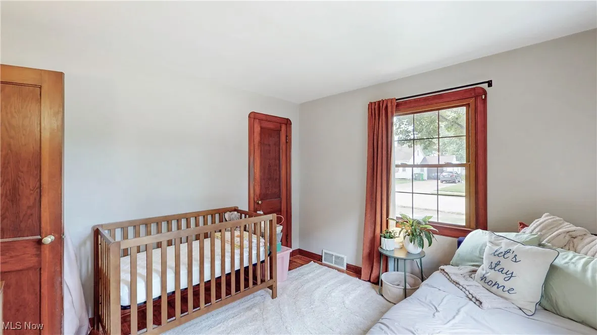 Bedroom featuring baseboards and wood finished floors