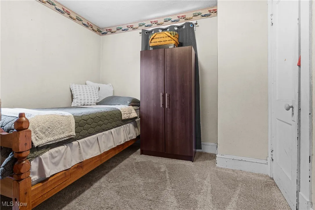 Bedroom with carpet flooring and baseboards