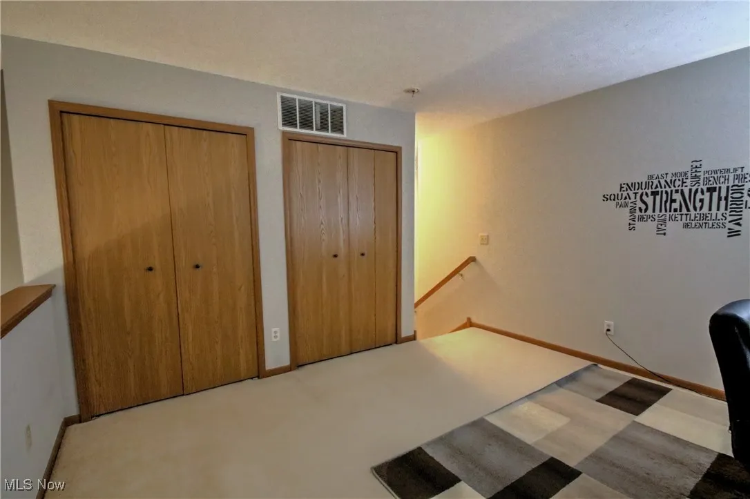 Unfurnished office featuring carpet floors and baseboards