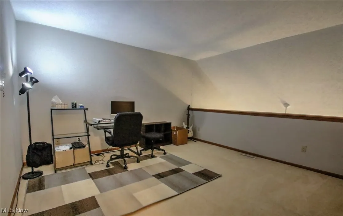 Carpeted office with baseboards