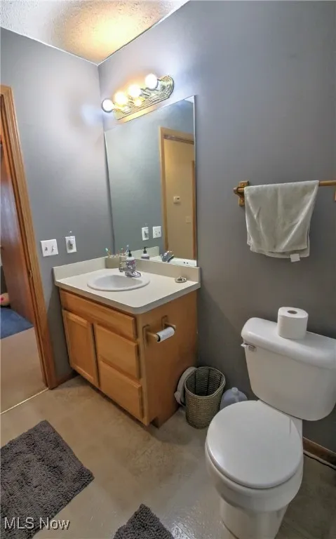 Bathroom featuring vanity and a textured ceiling