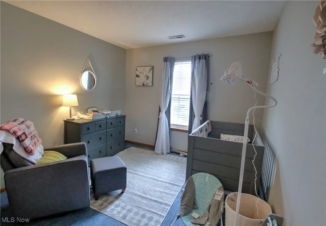 Carpeted bedroom with baseboards