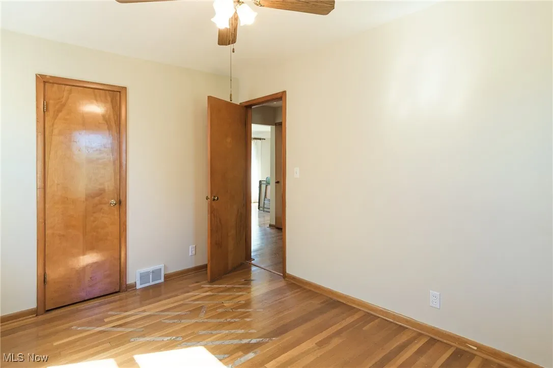 Unfurnished bedroom featuring light wood-style floors and a ceiling fan
