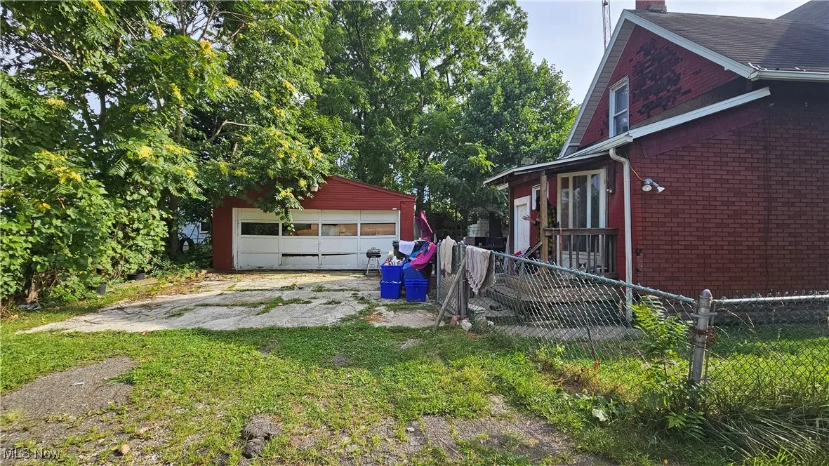 View of yard with an outbuilding and a detached garage