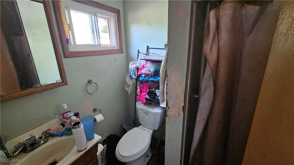 Bathroom featuring vanity and curtained shower