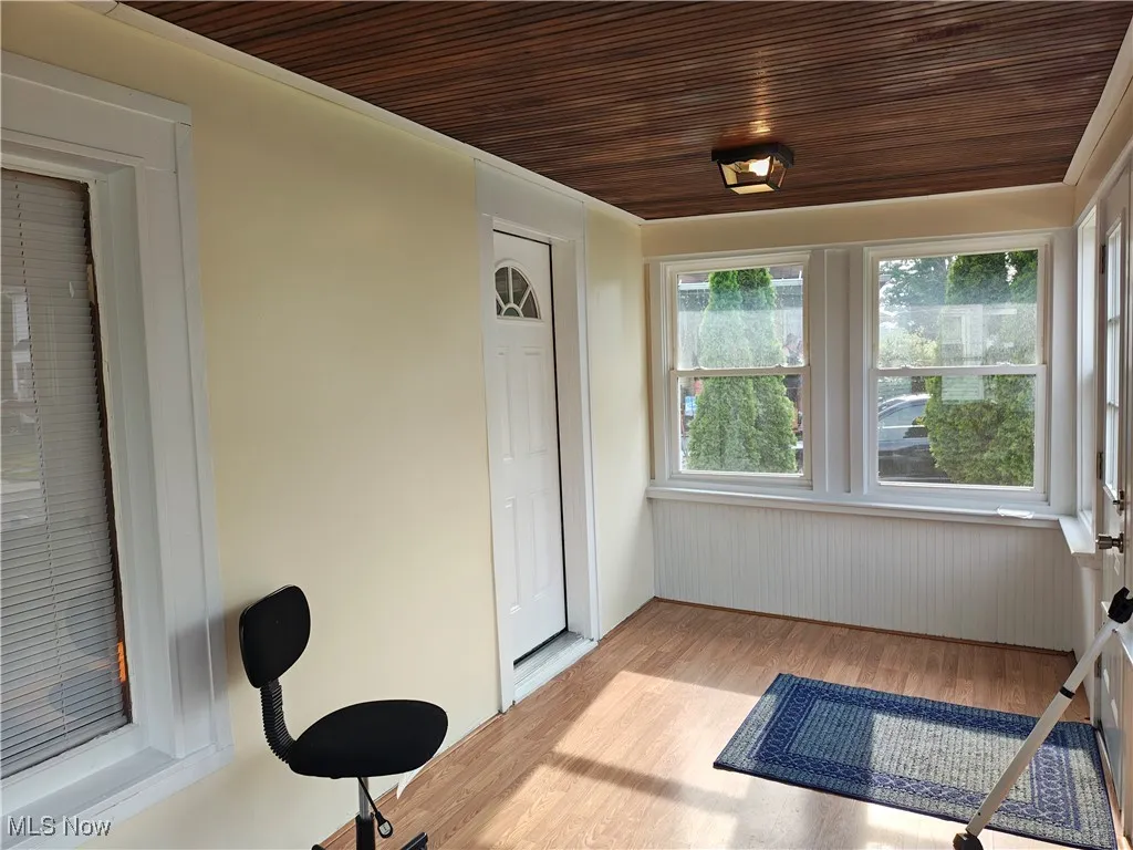 Sunroom featuring wood finished floors and wooden ceiling
