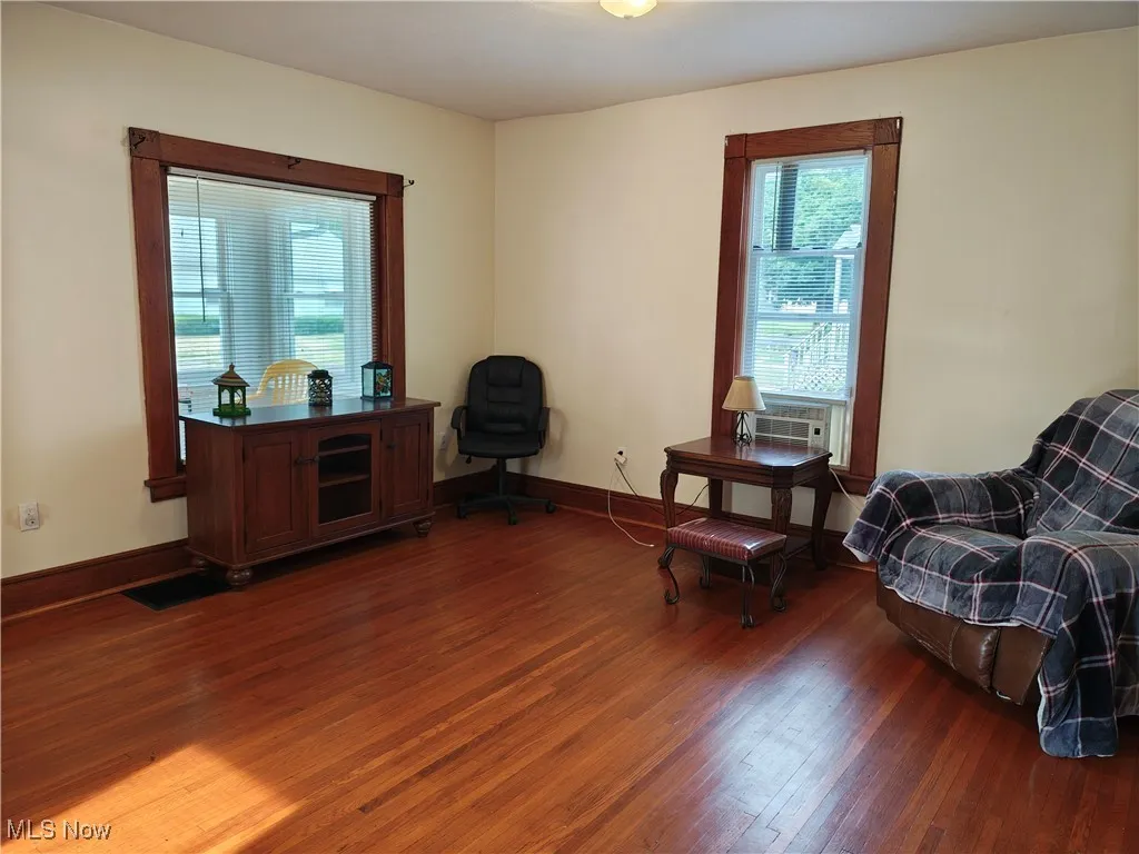 Sitting room with wood finished floors and baseboards