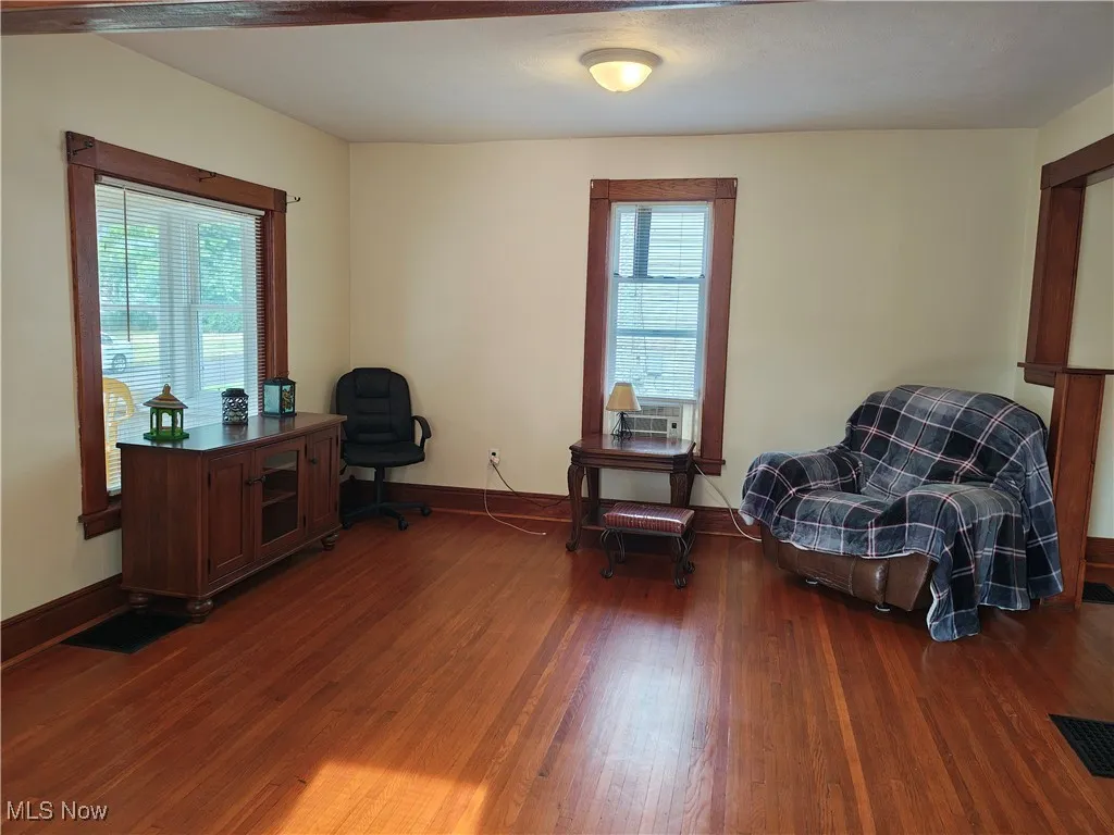 Home office with healthy amount of natural light and wood finished floors