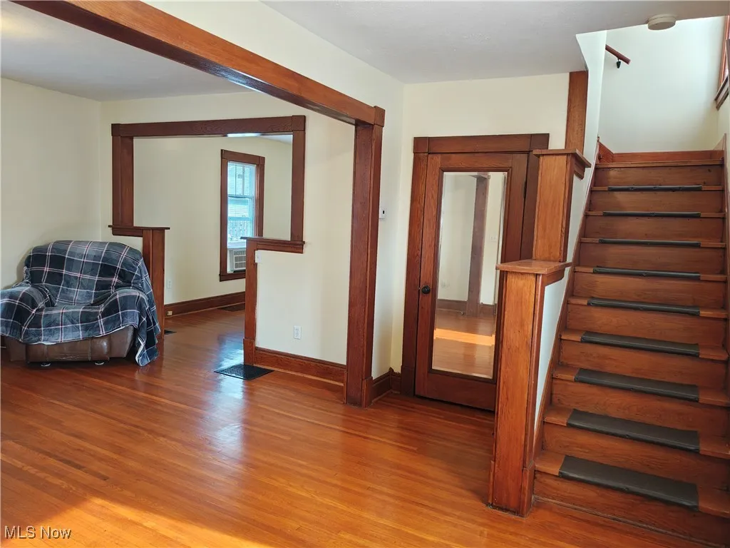 Staircase with wood finished floors and baseboards