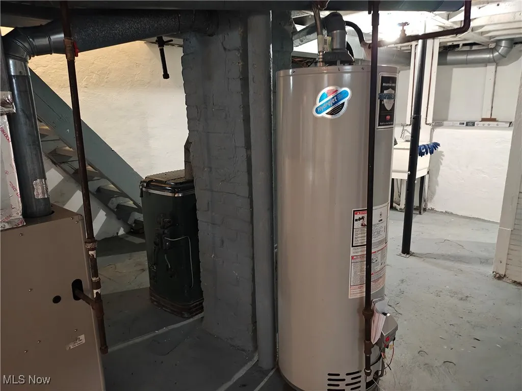 Utility room with gas water heater and heating unit