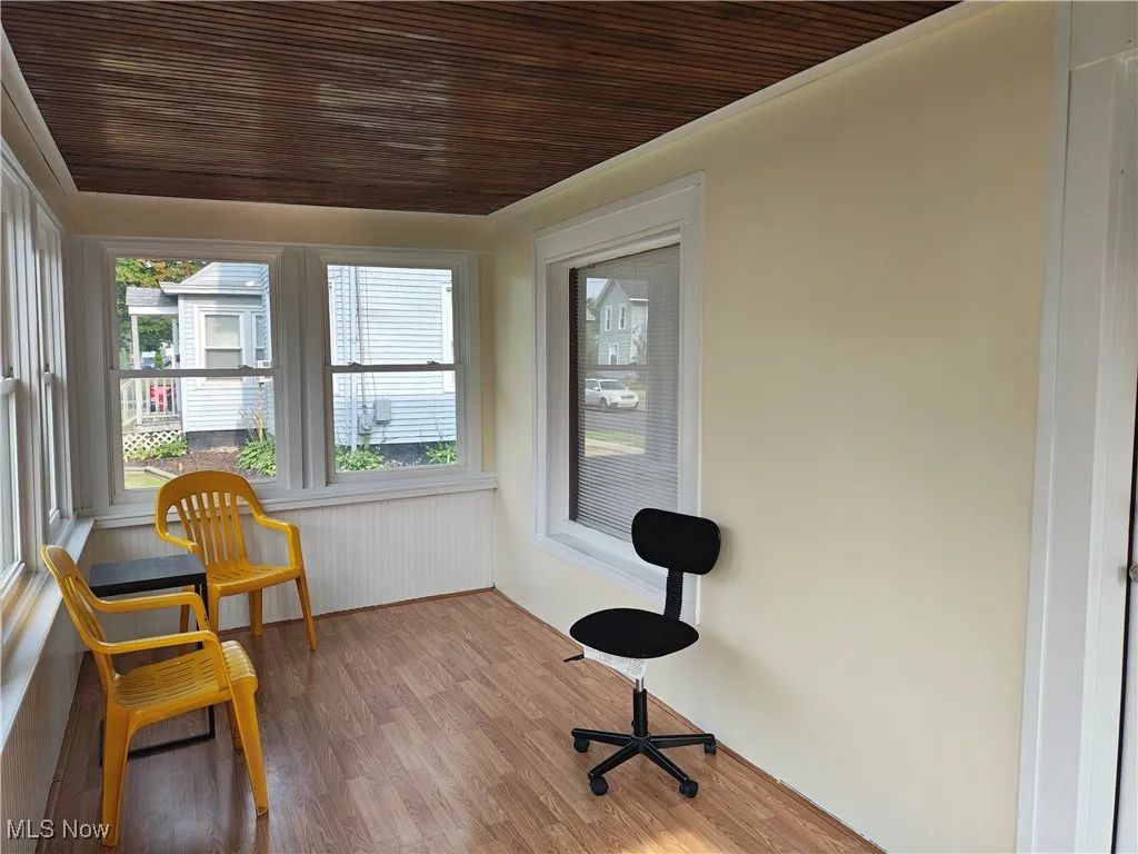 Sunroom / solarium featuring wood finished floors and wood ceiling