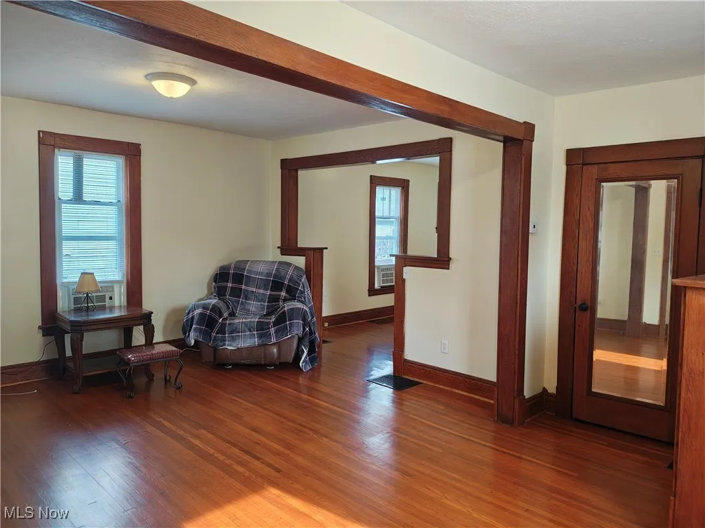 Sitting room with plenty of natural light and wood finished floors