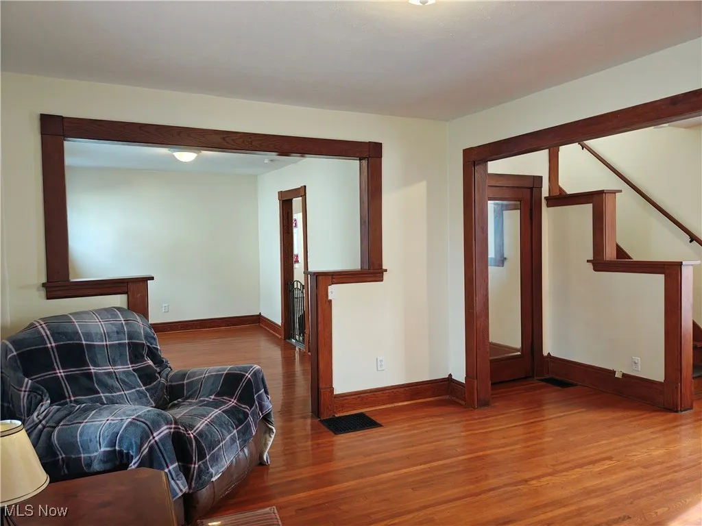 Living area featuring stairway and wood finished floors