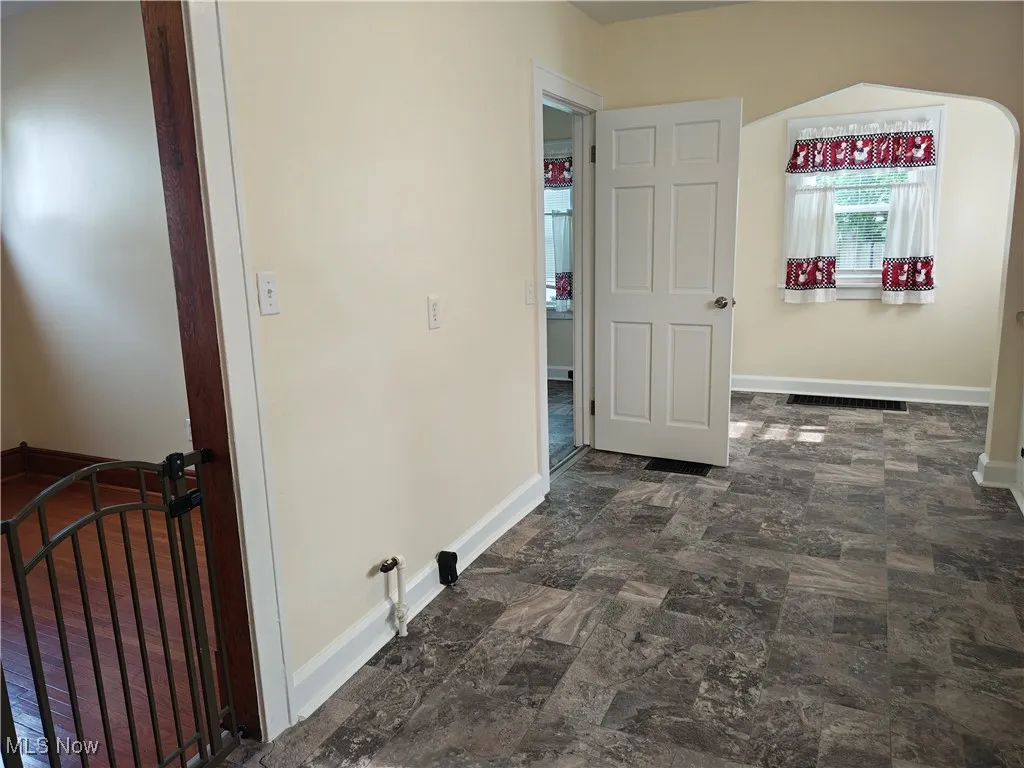 Hall featuring stone finish floors and arched walkways