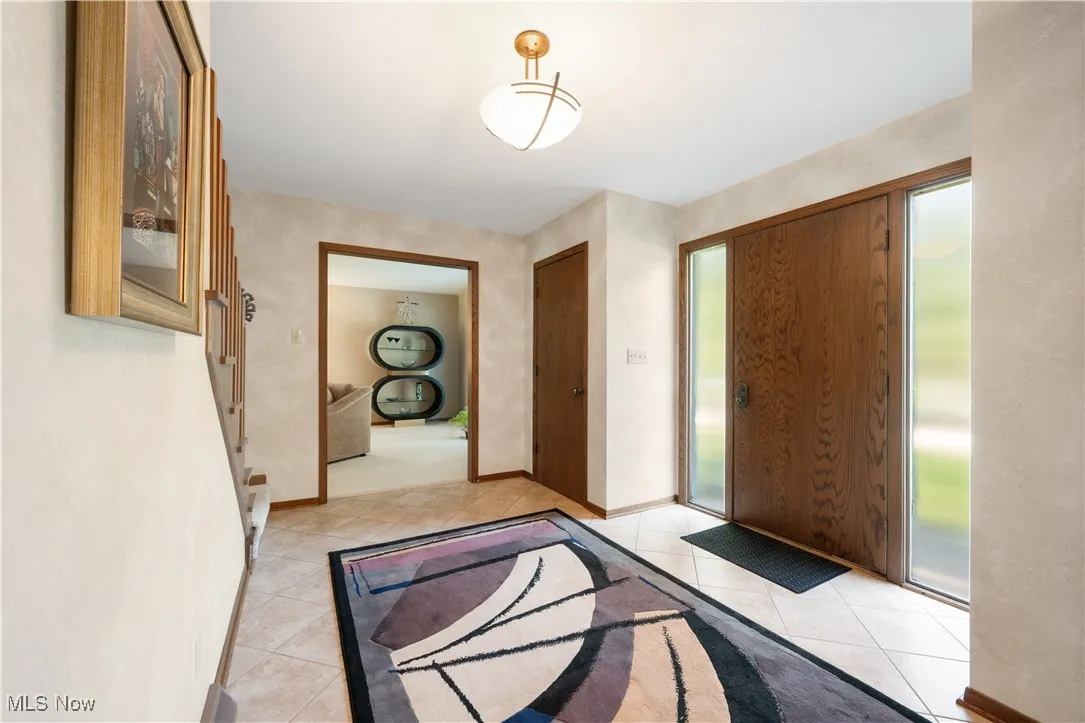Entryway with light tile patterned floors