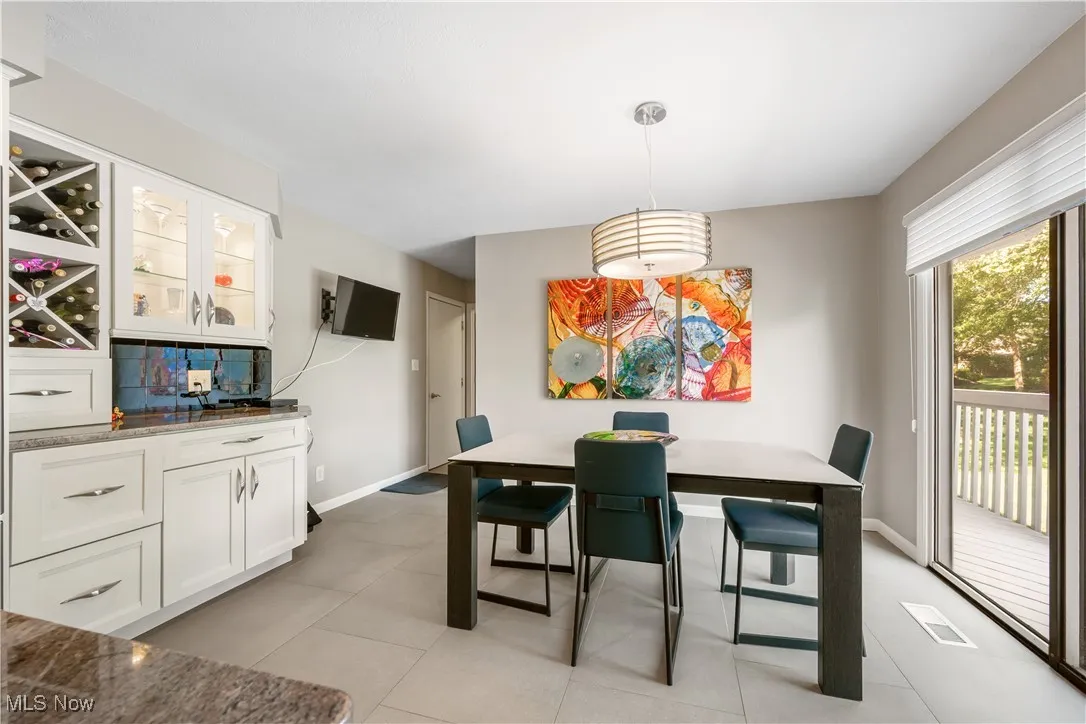Dining area with baseboards and light tile patterned floors