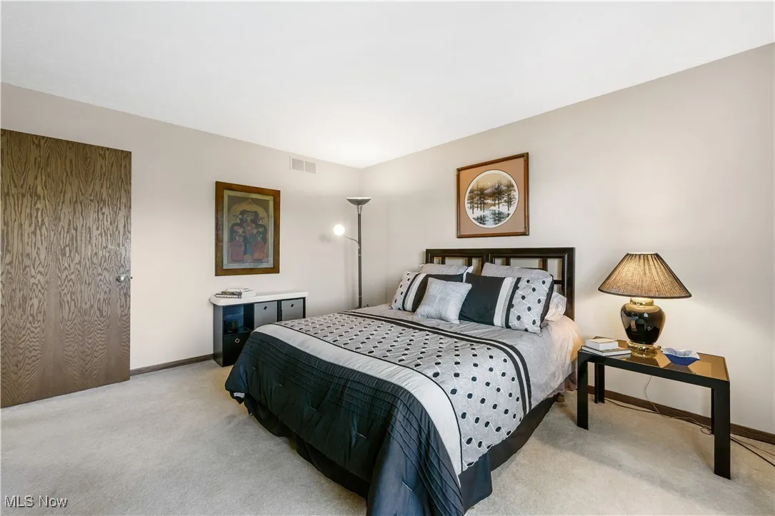Bedroom featuring light colored carpet
