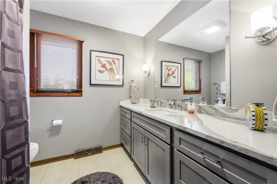 Bathroom with vanity and tile patterned floors