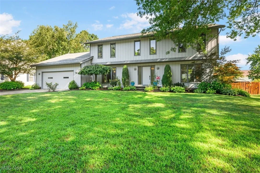View of front of property featuring an attached garage and driveway