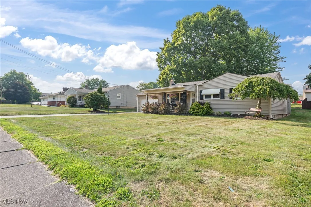 Ranch-style house with an attached garage and a front lawn