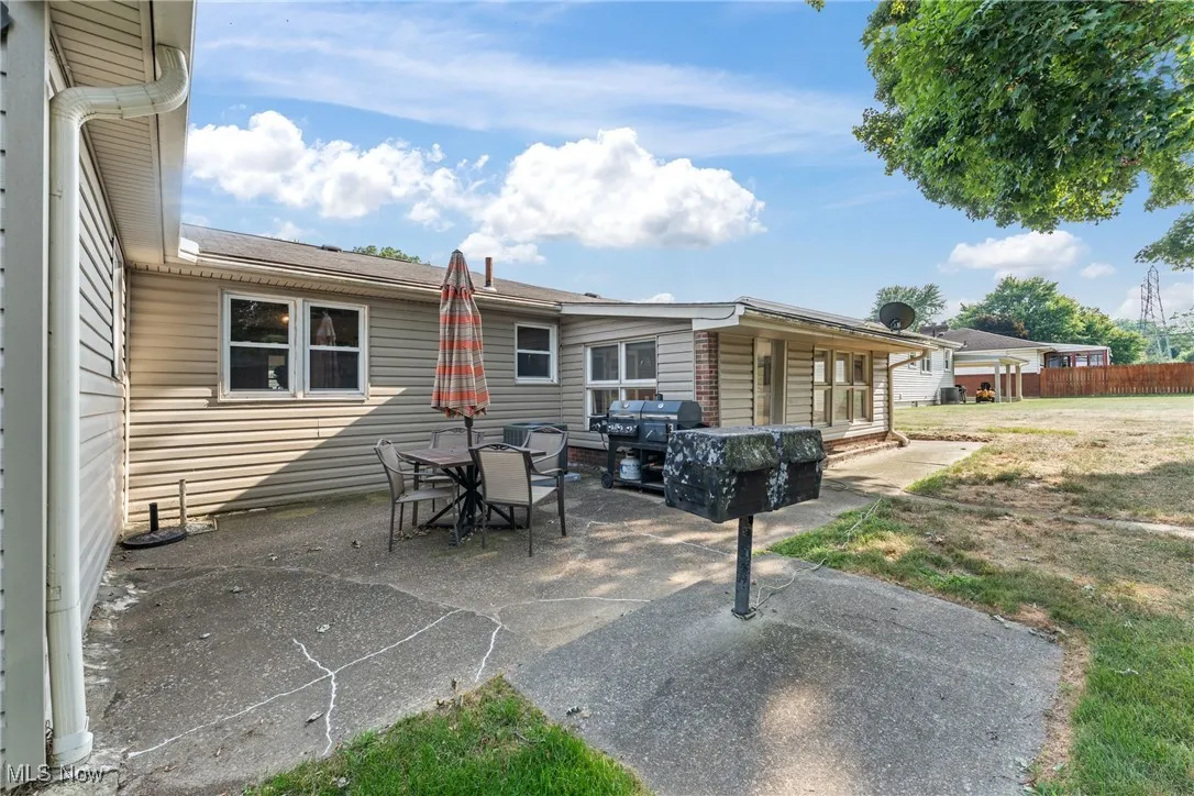 Back of house with a patio and outdoor dining space