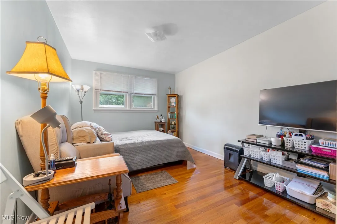 Bedroom with wood finished floors and baseboards