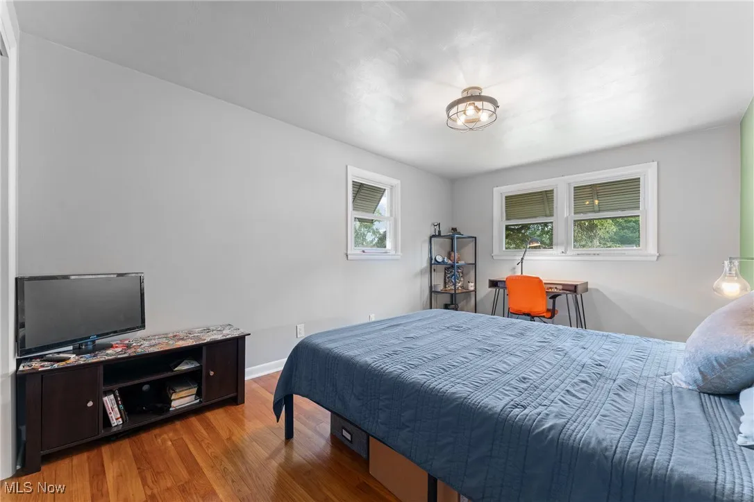 Bedroom featuring wood finished floors and baseboards
