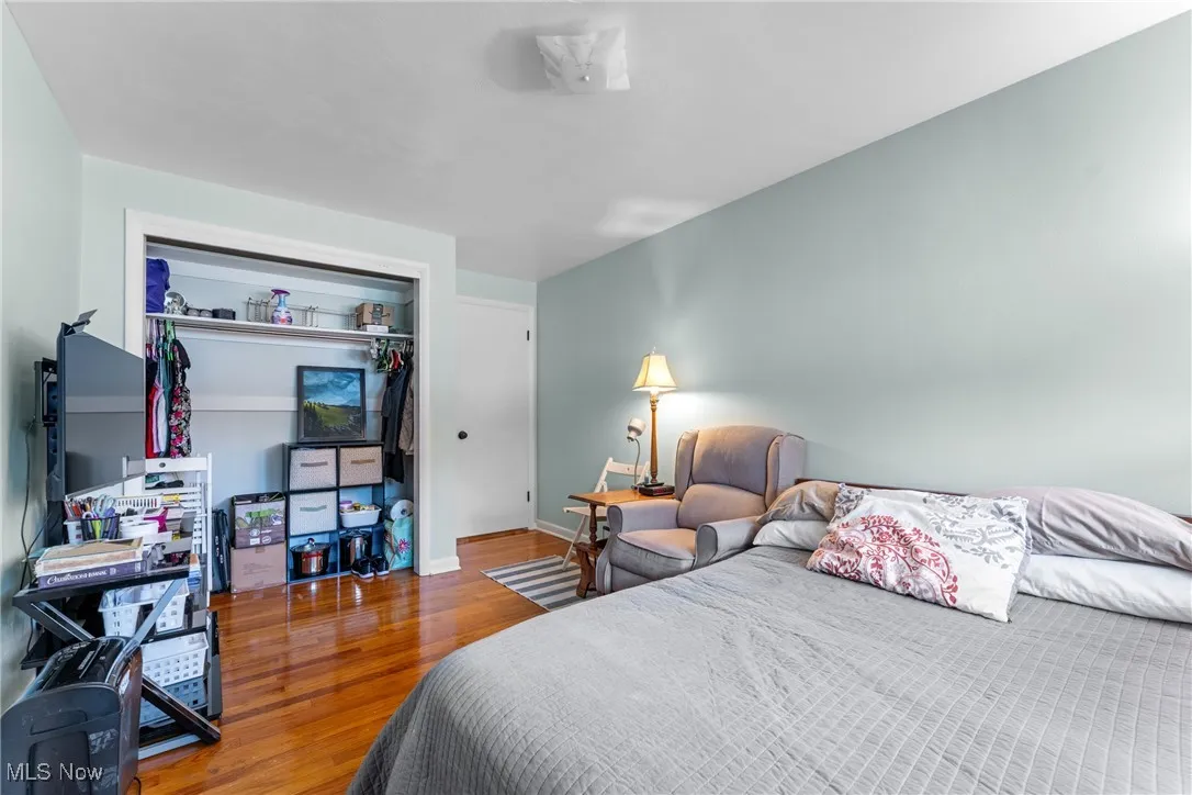 Bedroom featuring wood finished floors and a closet