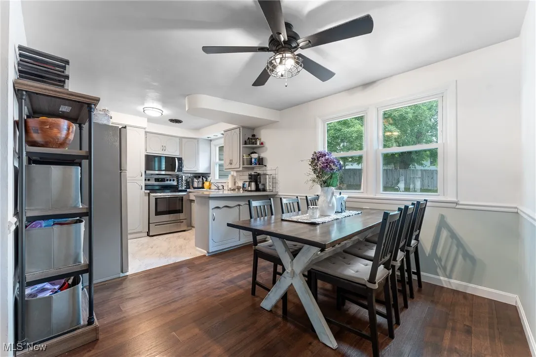 Dining area with wood finished floors and a ceiling fan