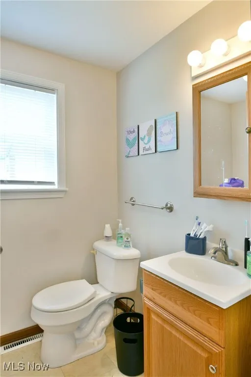 Half bath featuring vanity and tile patterned floors