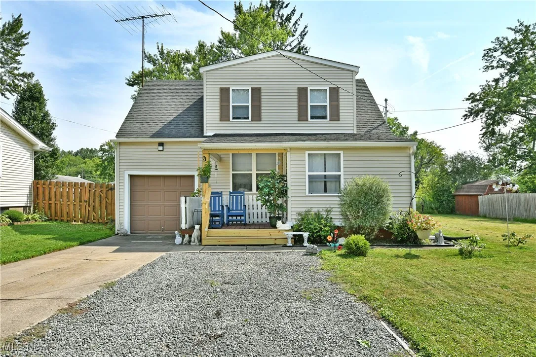 View of front of home with concrete driveway, a garage, and a shingled roof